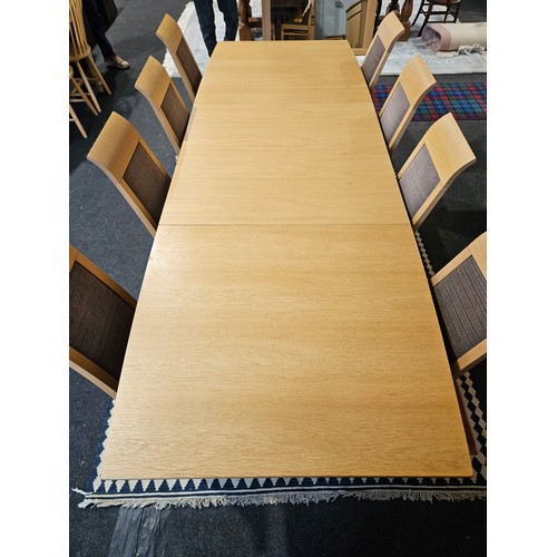 1019 - An oak extending dining table with two extra leaves, approximately 265cm long x 95cm wide extended, ... 