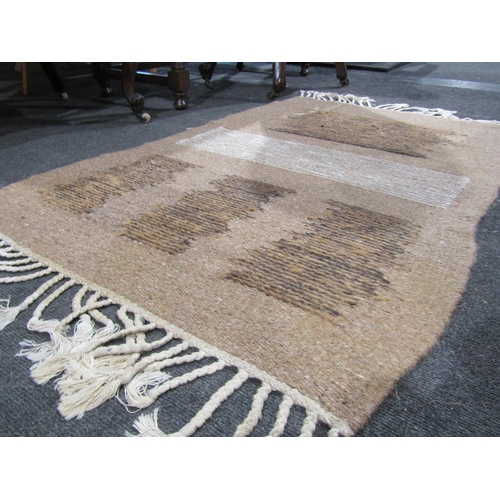 1027 - A handmade rug of brown lines with central white row detail, plaited tassel ends, 122cm x 78cm
