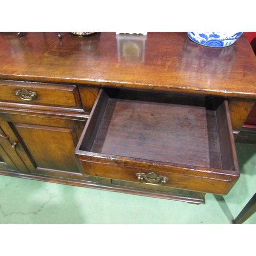4031 - An 18th Century revival oak dresser base with three drawers over three door cupboards having fielded... 