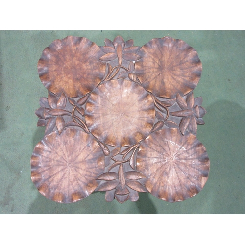 4005 - An occasional table with carved floral and lily pad decoration, on folding base, 43cm tall, loss to ... 