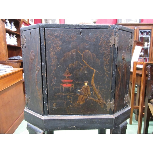 4007 - A Chinoiserie lacquered cabinet on stand with gilt figural and bird embellishment, three doors openi... 