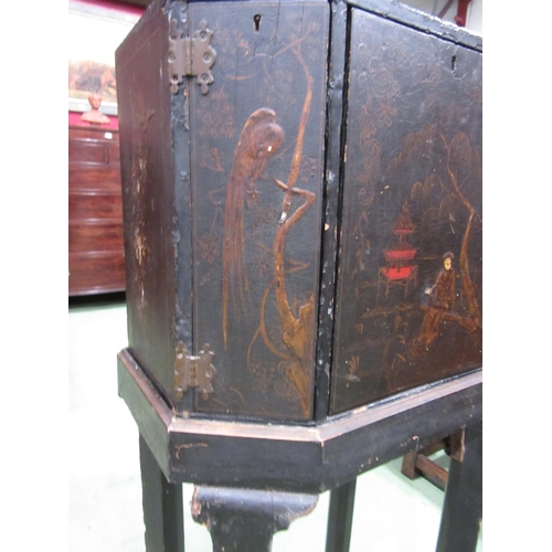 4007 - A Chinoiserie lacquered cabinet on stand with gilt figural and bird embellishment, three doors openi... 