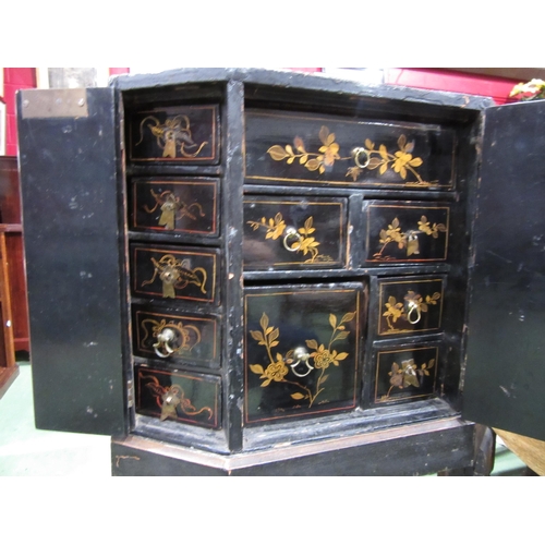 4007 - A Chinoiserie lacquered cabinet on stand with gilt figural and bird embellishment, three doors openi... 