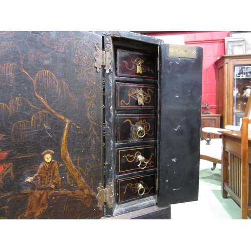 4007 - A Chinoiserie lacquered cabinet on stand with gilt figural and bird embellishment, three doors openi... 