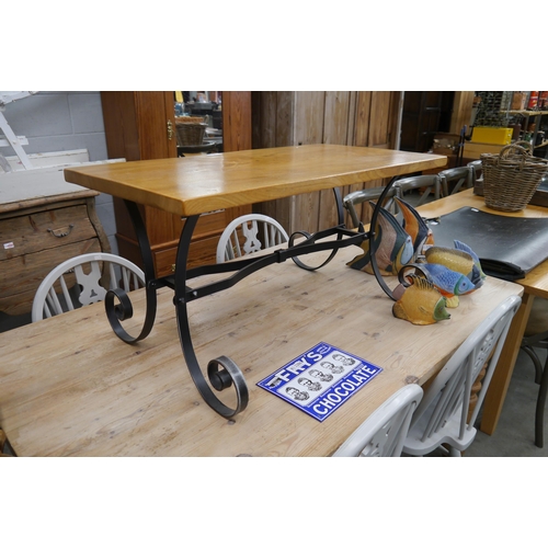 2029 - An oak top coffee table on wrought scrolled base