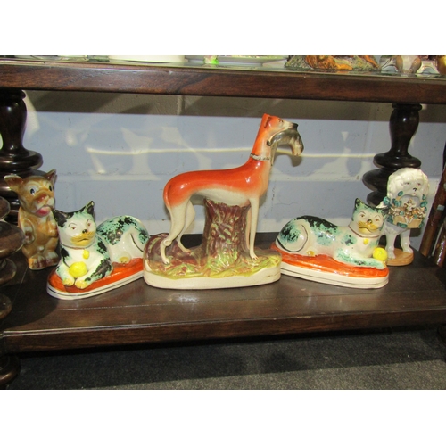 1047 - Five pottery animal figures including a Staffordshire Greyhound holding a hare