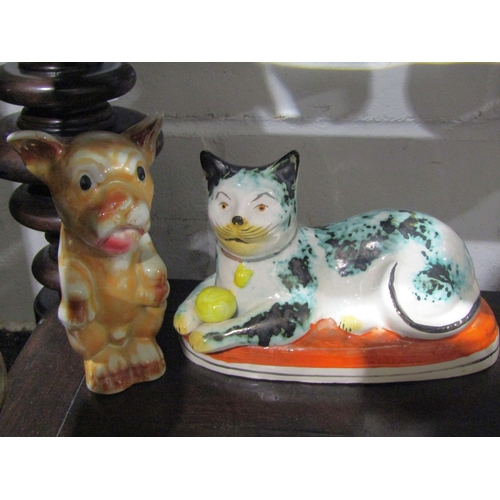 1047 - Five pottery animal figures including a Staffordshire Greyhound holding a hare