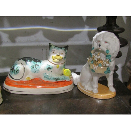 1047 - Five pottery animal figures including a Staffordshire Greyhound holding a hare