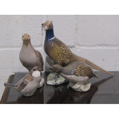 1051 - Four Royal Copenhagen bird figures, to include Partridge model No.2261, another, Pheasant and Sparro... 