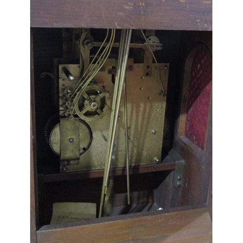 1117 - An Edwardian oak cased bracket clock with key and pendulum
