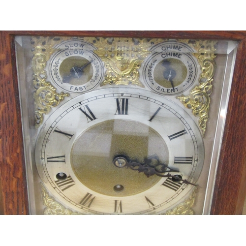 1117 - An Edwardian oak cased bracket clock with key and pendulum