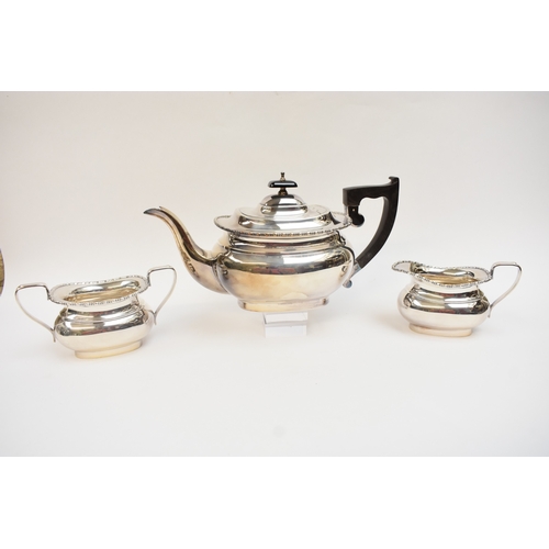 5006 - An Emile Viner silver three piece tea set with treen handle, Sheffield 1966.  1152g