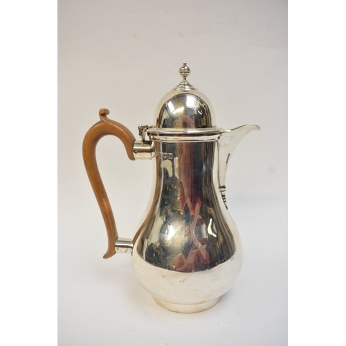 5021 - An Edwardian silver lidded jug of baluster form, with light wood handle. London 1908. By Lambert & C... 