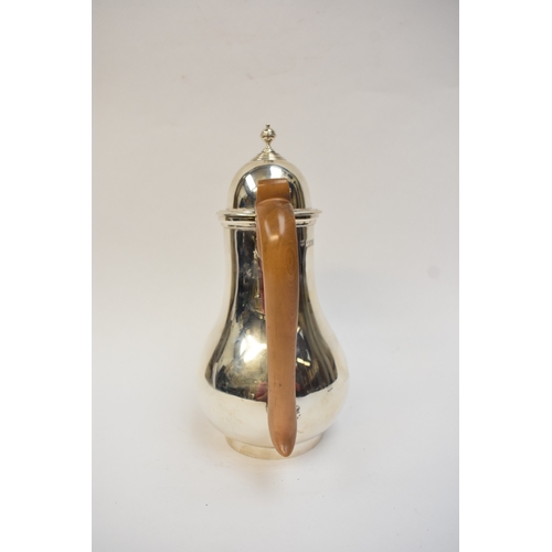 5021 - An Edwardian silver lidded jug of baluster form, with light wood handle. London 1908. By Lambert & C... 