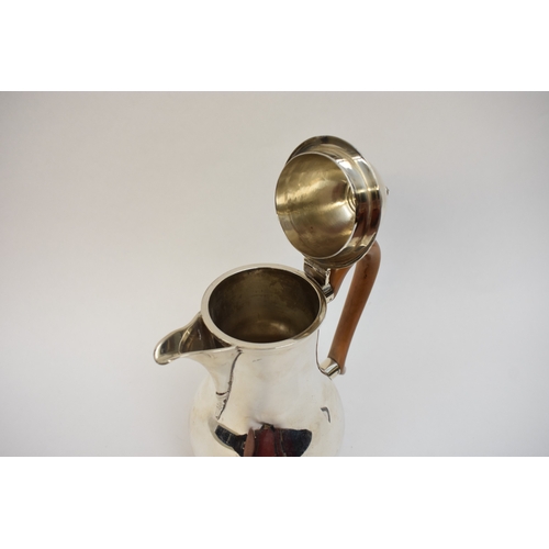 5021 - An Edwardian silver lidded jug of baluster form, with light wood handle. London 1908. By Lambert & C... 