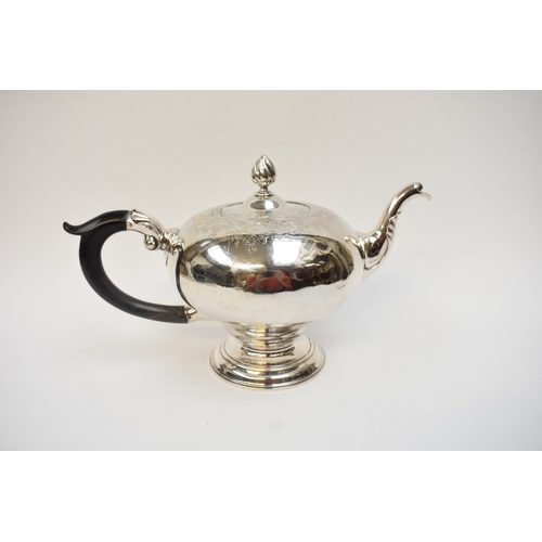 5003 - A George II silver pedestal ogee-shaped teapot, with foliate-chased shoulders, engraved crest, and e... 