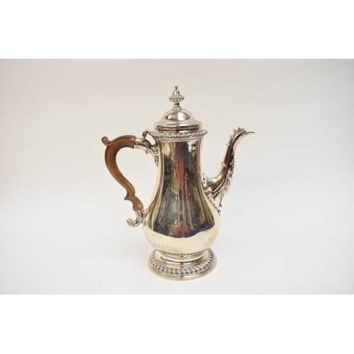 5004 - A George III silver coffee pot of baluster form, with hinged lid, finely-cast rims, foliate-sheathed... 