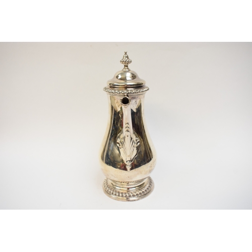 5004 - A George III silver coffee pot of baluster form, with hinged lid, finely-cast rims, foliate-sheathed... 