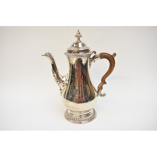 5004 - A George III silver coffee pot of baluster form, with hinged lid, finely-cast rims, foliate-sheathed... 