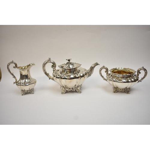 5023 - An early Victorian silver three-piece tea set, comprising a teapot of lobed gourd form, with foliate... 