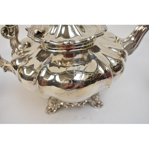 5023 - An early Victorian silver three-piece tea set, comprising a teapot of lobed gourd form, with foliate... 