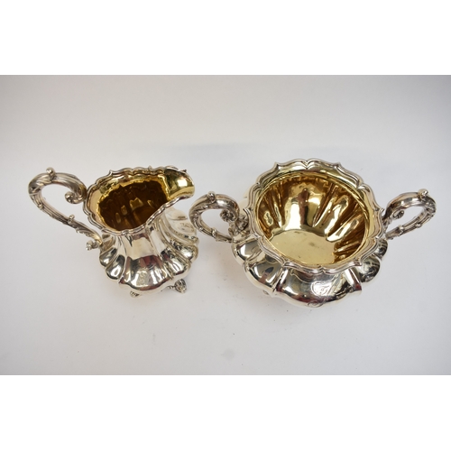5023 - An early Victorian silver three-piece tea set, comprising a teapot of lobed gourd form, with foliate... 