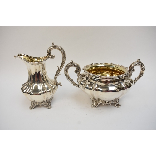 5023 - An early Victorian silver three-piece tea set, comprising a teapot of lobed gourd form, with foliate... 