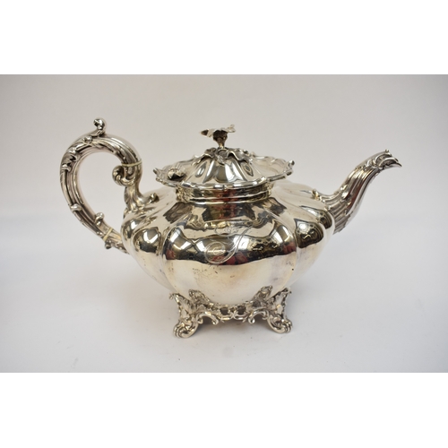 5023 - An early Victorian silver three-piece tea set, comprising a teapot of lobed gourd form, with foliate... 