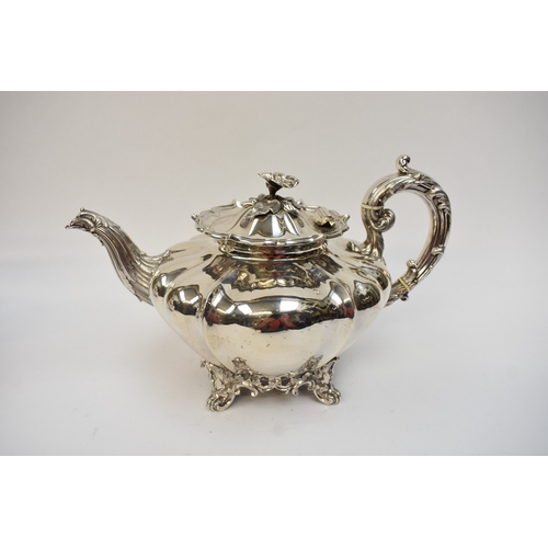 5023 - An early Victorian silver three-piece tea set, comprising a teapot of lobed gourd form, with foliate... 
