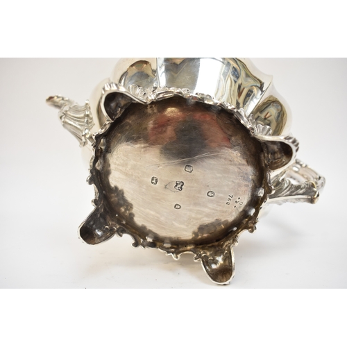 5023 - An early Victorian silver three-piece tea set, comprising a teapot of lobed gourd form, with foliate... 