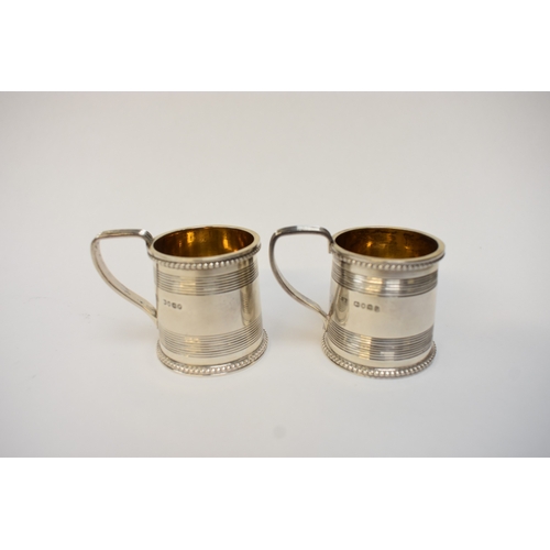 5032 - A pair of Victorian silver miniature tankards in the George III style, each with beaded rims, tramli... 