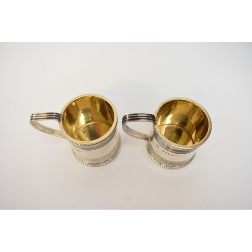 5032 - A pair of Victorian silver miniature tankards in the George III style, each with beaded rims, tramli... 