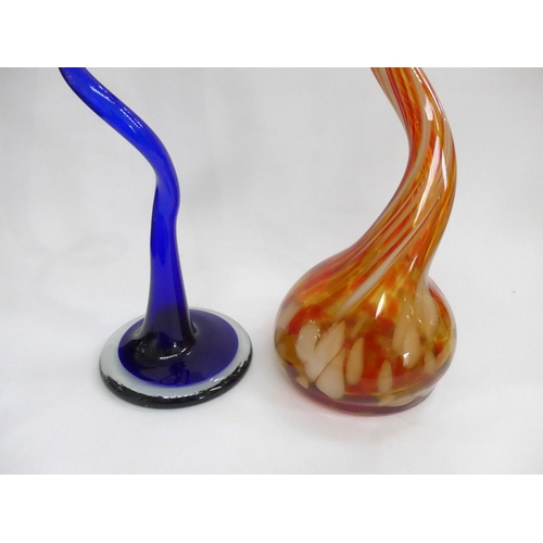 4030 - Two Continental glass 'corkscrew' stem vases, one in blue, one red and caramel mottled colours. Tall... 