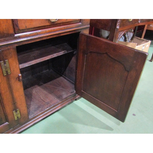 4036 - An 18th Century revival oak dresser base with three drawers over three door cupboards having fielded... 