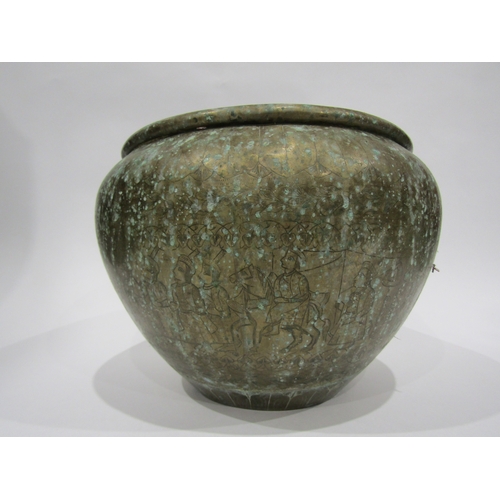 4005 - An Eastern brass jardiniere with embossed design, 30cm diameter, 22cm tall