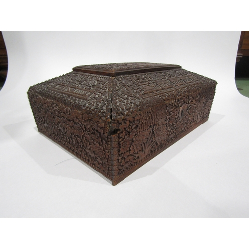 4011 - A late 19th/early 20th Century Chinese carved wooden jewellery box, flora/fauna carving with buildin... 