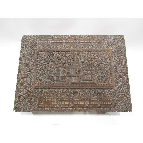 4011 - A late 19th/early 20th Century Chinese carved wooden jewellery box, flora/fauna carving with buildin... 