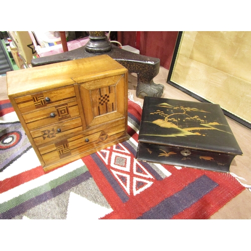 4013 - A Japanese lacquered box in the form of a book, waterside village scene to lid, together with an inl... 