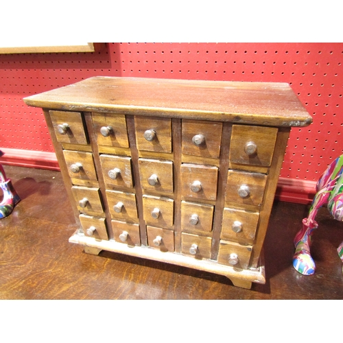 4034 - A table-top chest of twenty drawers for trinkets, 30cm tall x 35cm wide x 19cm deep