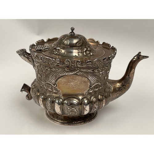 5005 - A Victorian Wakely & Wheeler silver bachelor's three piece tea set with embossed floral, leaf and sc... 