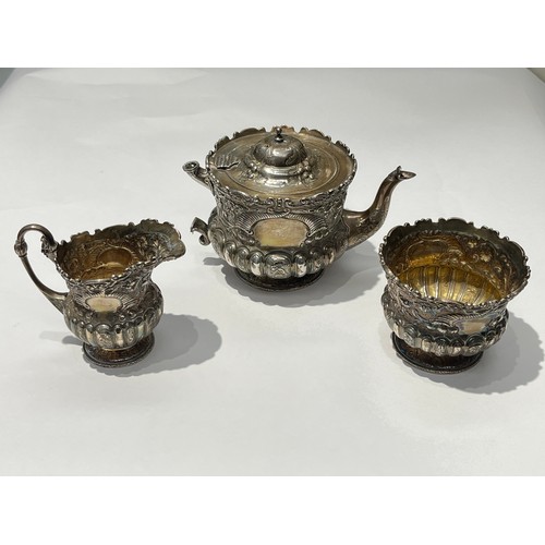 5005 - A Victorian Wakely & Wheeler silver bachelor's three piece tea set with embossed floral, leaf and sc... 