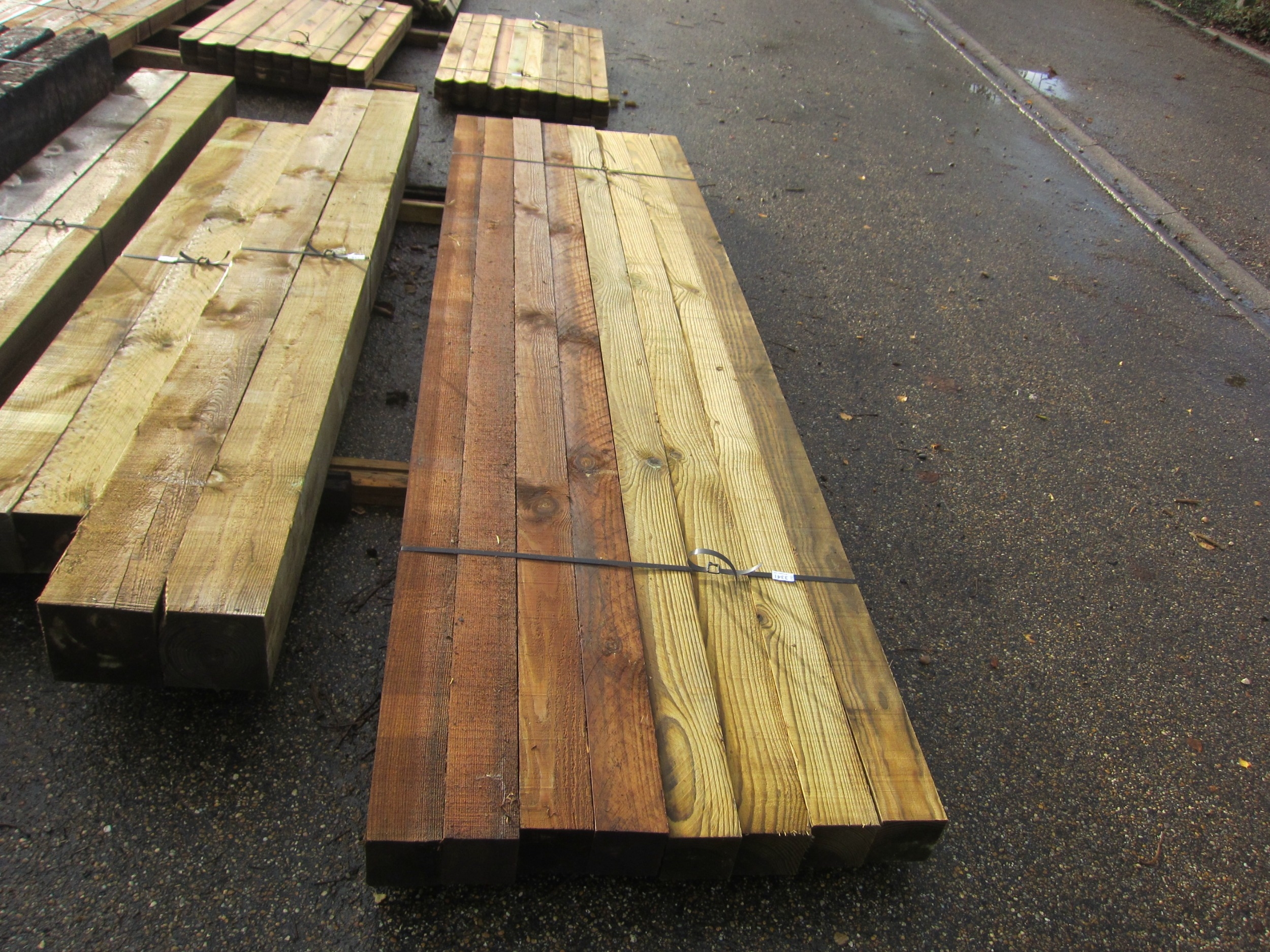 Eight 10' x 4" x 4" pressure treated fence posts