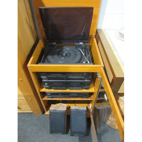 1029 - A cabinet containing a collection of Sharp stereo equipment to include tape and CD player