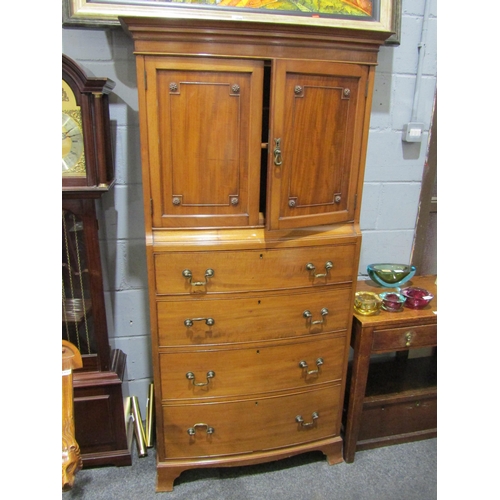 1050 - A reproduction walnut two door cabinet over four drawer bow front chest on bracket feet, 170cm tall ... 