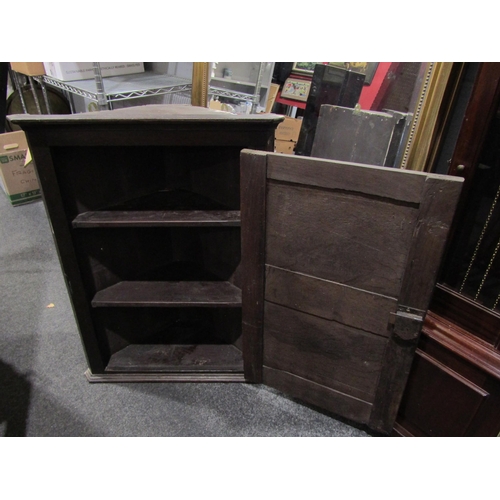 1055 - A Georgian oak wall hanging corner cupboard, with key, 84cm tall x 65cm wide