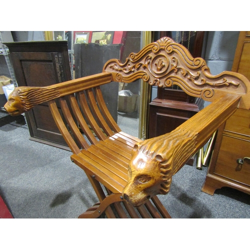 1056 - An Asian folding chair with lion mask arm rests