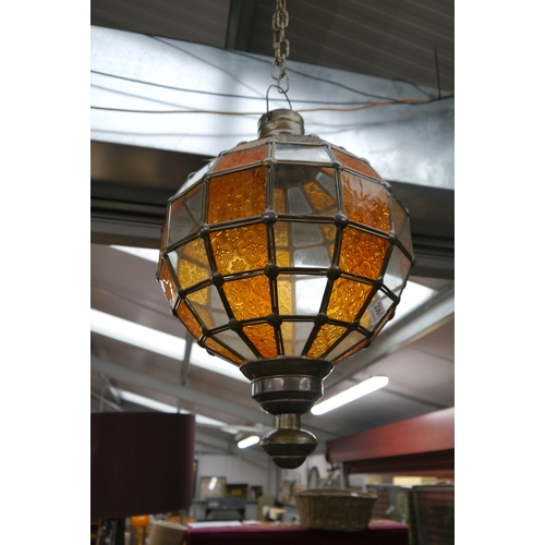 2061 - An Eastern brass and amber stained glass globe lantern
