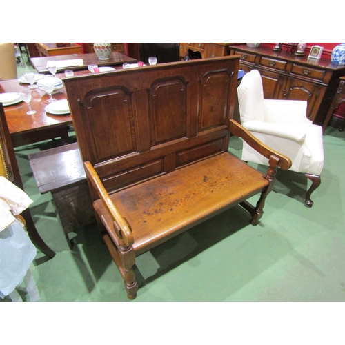 4003 - A 17th Century revival oak three panel back hall settle the scroll arms on turned supports united by... 