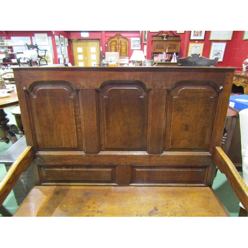 4003 - A 17th Century revival oak three panel back hall settle the scroll arms on turned supports united by... 