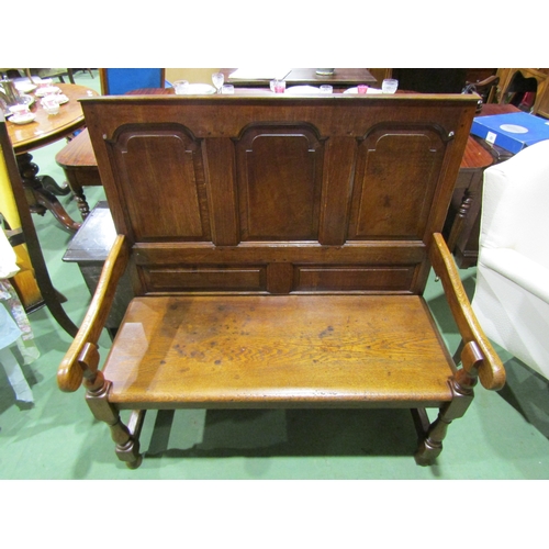 4003 - A 17th Century revival oak three panel back hall settle the scroll arms on turned supports united by... 